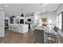 Open floor plan features a modern kitchen open to a dining area with contemporary lighting and ample seating at 208 Wade Creek Rd, Alpharetta, GA 30009
