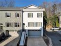 Charming townhome showcasing a private garage, gray accents, an entryway, and meticulous landscaping at 208 Wade Creek Rd, Alpharetta, GA 30009