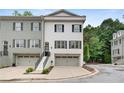 Beautiful townhome featuring a two-car garage, a neatly kept lawn, and easy access to local roads at 208 Wade Creek Rd, Alpharetta, GA 30009