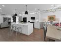 Modern kitchen with a large island, white cabinets, stainless appliances, and open to dining area at 208 Wade Creek Rd, Alpharetta, GA 30009