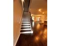 Entryway with hardwood floors that leads to a spacious living room with white trim stairs and dark brown handrail at 2778 Wild Laurel Ct, Norcross, GA 30071