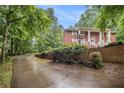 View of the property's long paved driveway winding through the greenery leading up to the house at 5247 Yeager Rd, Douglasville, GA 30135