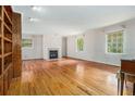 Spacious living room with hardwood floors, a fireplace, and built-in shelving at 5247 Yeager Rd, Douglasville, GA 30135