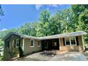 Charming home with neutral siding, black shutters, and mature landscaping at 364 Stafford Sw St, Marietta, GA 30064