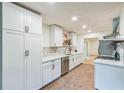 Bright kitchen features white cabinets, modern countertops, stainless steel appliances, and stylish backsplash at 364 Stafford Sw St, Marietta, GA 30064