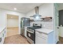 Bright kitchen boasts stainless steel appliances, gas range, ample storage, and modern countertops at 364 Stafford Sw St, Marietta, GA 30064
