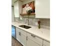 Bright kitchen featuring white cabinets, stainless steel sink, and modern countertops at 364 Stafford Sw St, Marietta, GA 30064