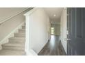 Bright foyer with wood flooring, gray walls, and carpeted staircase at 2804 Georgia Aster Way Nw, Atlanta, GA 30318