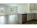 Open-concept kitchen with granite countertops and stainless steel appliances at 2804 Georgia Aster Way Nw, Atlanta, GA 30318