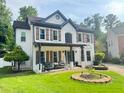 Charming two-story home with a covered porch, shutters, and well-maintained lawn at 710 Oxford Crest Ct, Lawrenceville, GA 30043