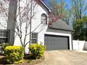 Attached two-car garage offers convenience and security at 710 Oxford Crest Ct, Lawrenceville, GA 30043