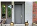 Close up of the entryway featuring a modern door, brick accents, and stylish planters at 1251 Chelsea Nw Cir # 30, Atlanta, GA 30318