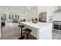 Modern kitchen features a large island with seating and stainless steel appliances at 1251 Chelsea Nw Cir # 30, Atlanta, GA 30318