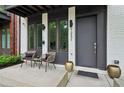 Inviting front porch with contemporary seating, sleek planters, and a modern entrance door at 1251 Chelsea Nw Cir # 30, Atlanta, GA 30318