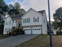 Two-story home with a two-car garage, brick accents, and a spacious driveway, located in a tree-filled area at 2775 Emerald Springs Dr, Lawrenceville, GA 30045