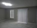 Bright living room featuring new flooring, fresh paint, and natural light from windows and sliding glass doors at 2775 Emerald Springs Dr, Lawrenceville, GA 30045