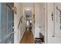 Inviting hallway featuring hardwood floors, white wainscoting, neutral paint, and decorative wall accents at 3829 Thayer Trce, Duluth, GA 30096