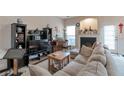 Comfortable living room with fireplace, neutral carpet, plenty of seating, and lots of natural light at 3829 Thayer Trce, Duluth, GA 30096