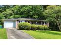 Single-story brick home featuring an attached garage and mature landscaping at 766 Virginia Cir, Forest Park, GA 30297