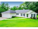 Charming one-story home with lush green lawn and well-maintained landscaping at 6328 Wellington Ct, Douglasville, GA 30134