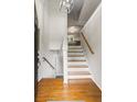 Bright foyer showcasing hardwood floors, a staircase, and an open view into the kitchen at 735 Waterbrook Ter, Roswell, GA 30076