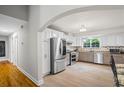 Bright kitchen with stainless steel appliances, granite countertops, and white cabinetry at 735 Waterbrook Ter, Roswell, GA 30076