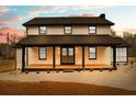 Charming two-story home with a welcoming front porch and a fresh, modern exterior at 260 Sandy Lake Cir, Fayetteville, GA 30214
