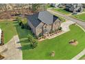 Aerial view of a well-maintained home with a lush green lawn and long driveway at 4580 Cloister Cir, Hampton, GA 30228