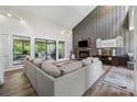 Open-concept living room showcases a stone fireplace, high ceilings, and comfortable sectional sofa at 4117 Signal Sw Rdg, Lilburn, GA 30047
