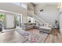 Spacious living room features a large sofa, high ceilings, and wood floors at 4117 Signal Sw Rdg, Lilburn, GA 30047
