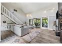 Bright living room with high ceilings, wood floors, and large glass sliding doors at 4117 Signal Sw Rdg, Lilburn, GA 30047