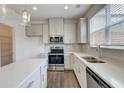 Bright kitchen with white cabinets, stainless steel appliances, and center island at 7682 Baron Rd, Fairburn, GA 30213