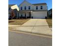 Charming two-story home with a well-manicured lawn and a two-car garage at 136 Paulownia Cir, Mcdonough, GA 30253