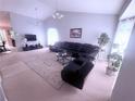 Spacious living room featuring high ceilings, large windows, plush carpeting, and comfortable seating at 2331 Georgia Lane, Snellville, GA 30078
