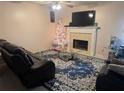 Cozy living room featuring a fireplace, ceiling fan, and an area rug with decorative furniture at 6438 Wedgeview Dr, Tucker, GA 30084