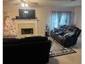 Comfortable living room with a fireplace, TV, and plush sofas, perfect for relaxation and entertaining at 6438 Wedgeview Dr, Tucker, GA 30084