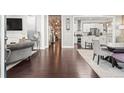 Open-concept living space with hardwood floors seamlessly connecting the living and dining areas at 1450 Elizabeth Ln, Atlanta, GA 30344