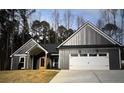 Charming single-story home featuring a symmetrical façade, attached garage, and well-manicured landscaping at 1847 Davis Mill Rd, Dallas, GA 30157