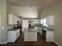 Well-appointed kitchen featuring white cabinets, stainless steel appliances, granite countertops, and a functional island at 3718 Jackson Bluff Dr, Lawrenceville, GA 30044