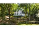 Charming exterior view of the home with a landscaped front yard and stone retaining wall at 6305 River Chase Cir, Atlanta, GA 30328