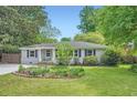 Quaint single story home with lush green lawn, garden and blue sky at 2205 Desmond Dr, Decatur, GA 30033