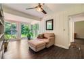 Cozy sunroom with hardwood floors, large windows, and comfortable seating area at 2205 Desmond Dr, Decatur, GA 30033