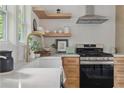 Stylish kitchen featuring modern appliances, and open shelving at 2244 Alpha Dr, Decatur, GA 30032
