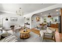 Open-concept living space with hardwood floors, shiplap accent wall, and seamless flow to the dining area at 2244 Alpha Dr, Decatur, GA 30032