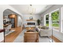 Bright living room featuring hardwood floors, a stylish fireplace, and an open floor plan at 2244 Alpha Dr, Decatur, GA 30032