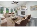 Bright living room featuring a fireplace, large windows, and neutral decor at 3066 Malvern Dr, Snellville, GA 30039