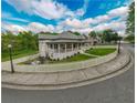 Exterior showcases a large yard, classic white picket fence, a fire pit area, and serene landscaping at 4527 Dallas St, Acworth, GA 30101
