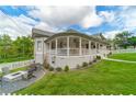 Side exterior displaying well-maintained yard, a fire pit with chairs, and classic design elements at 4527 Dallas St, Acworth, GA 30101