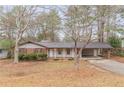 Well-maintained single-story home with covered parking, showcasing a cozy and inviting exterior at 50 Carriage Trce, Stockbridge, GA 30281