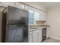 Functional kitchen featuring a stainless steel sink, granite countertops, and plenty of cabinet storage at 50 Carriage Trce, Stockbridge, GA 30281